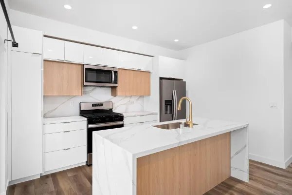 a kitchen with stainless steel appliances a sink stove and refrigerator