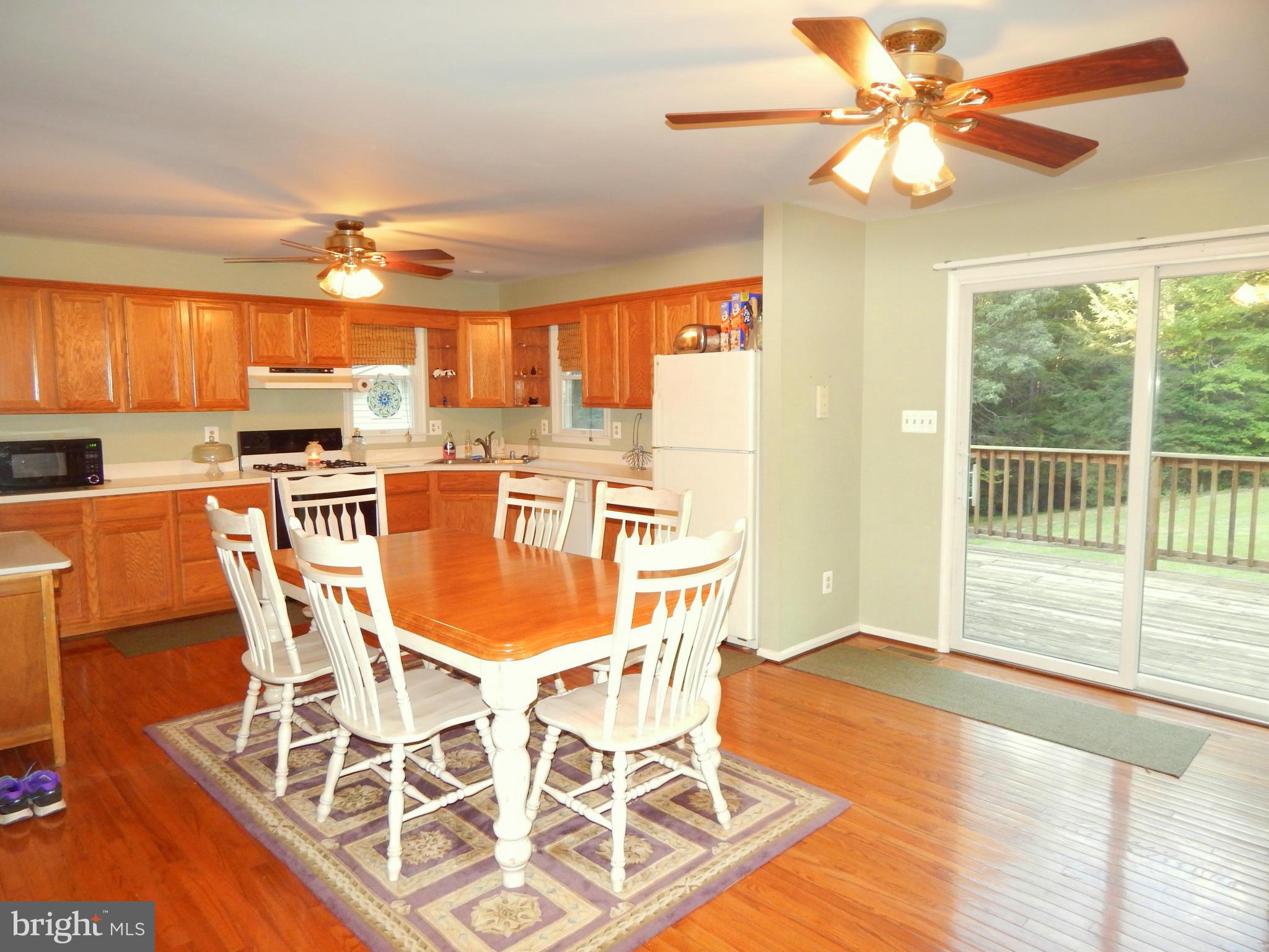 8246 Sinclair Mill Road Manassas, VA 20112 - Photo 5 of 30 Kitchen with Dining Area and Rear Deck Access