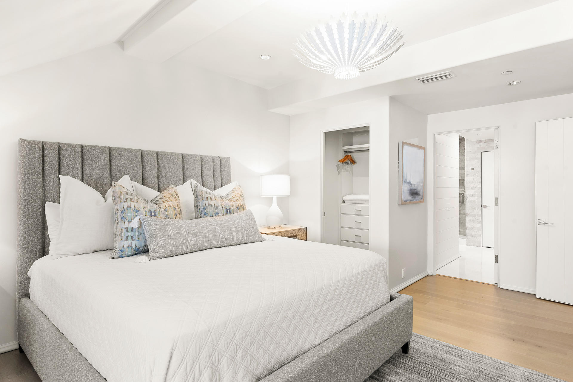 16 South Barrett Square, Unit 4 Inlet Beach, FL 32461 - Photo 70 of 98 a spacious bedroom with a bed and a chandelier