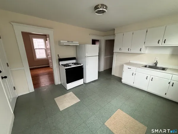 a kitchen with stainless steel appliances granite countertop a sink stove and cabinets