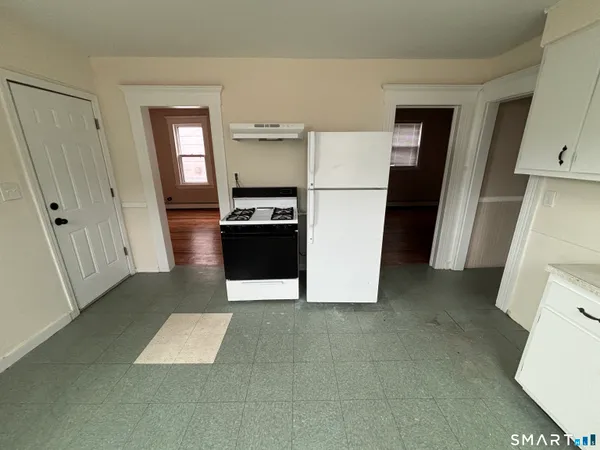 a view of a kitchen with storage and a sink