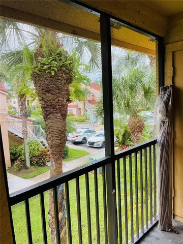 a view of a porch and a yard of a building