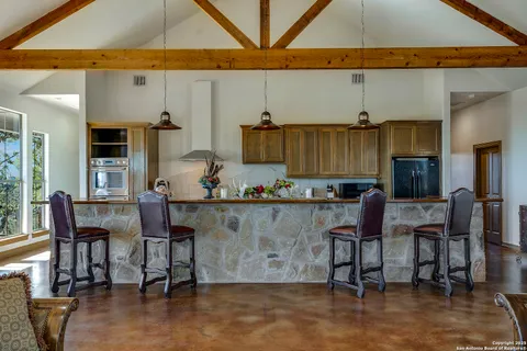 a living room with stainless steel appliances kitchen island granite countertop furniture and a kitchen view