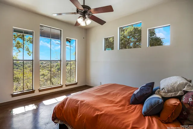 a bedroom with a bed and a large window
