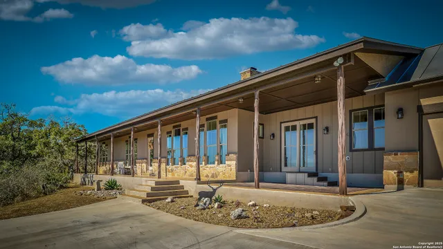 a view of a house with yard and sitting area