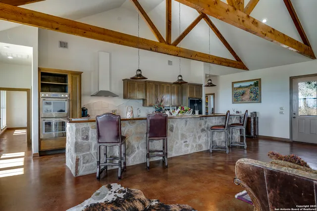 a living room with furniture a wooden floor and a sink