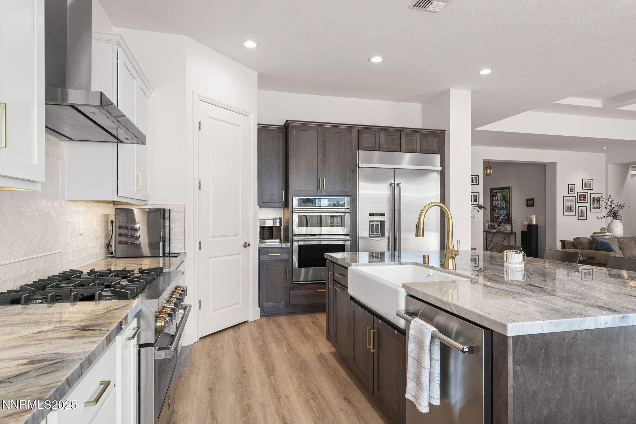 2310 Stone Rise Road Reno, NV 89521 - Photo 9 of 28 a kitchen with kitchen island granite countertop a stove oven and a sink with wooden floor