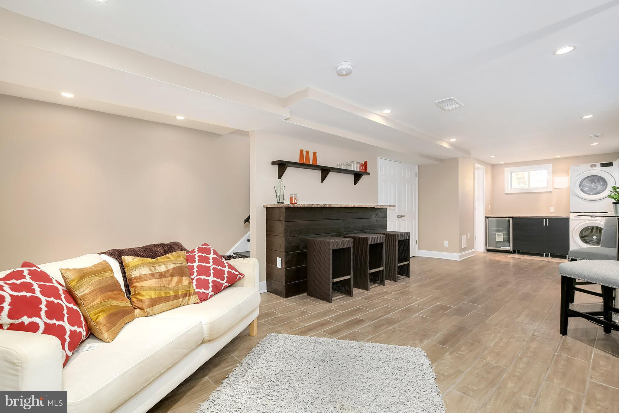 4822 Sargent Road Northeast Washington, DC 20017 - Photo 22 of 30 a living room with furniture and a fireplace