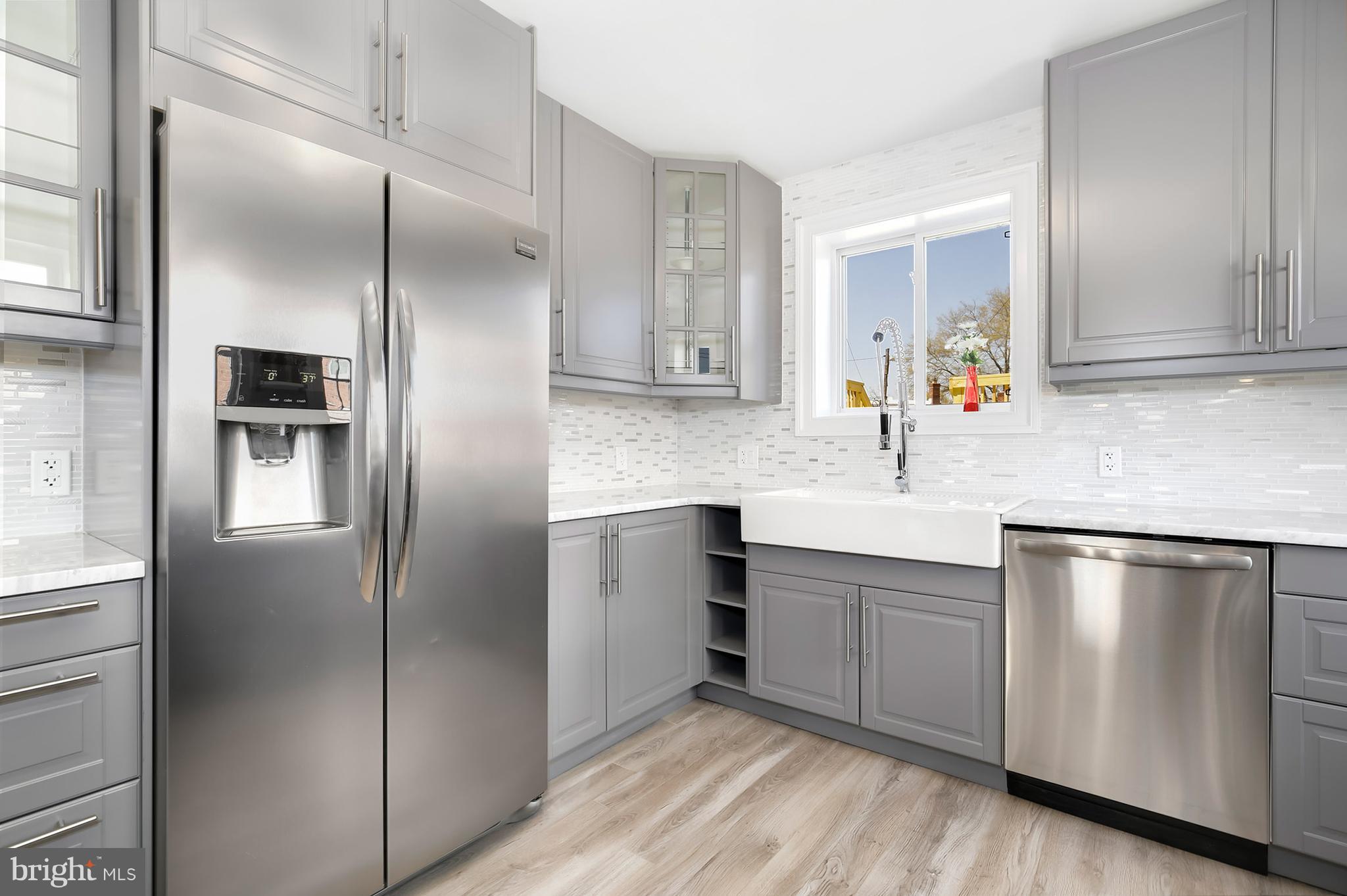 4822 Sargent Road Northeast Washington, DC 20017 - Photo 10 of 30 a kitchen with stainless steel appliances granite countertop a refrigerator and a sink