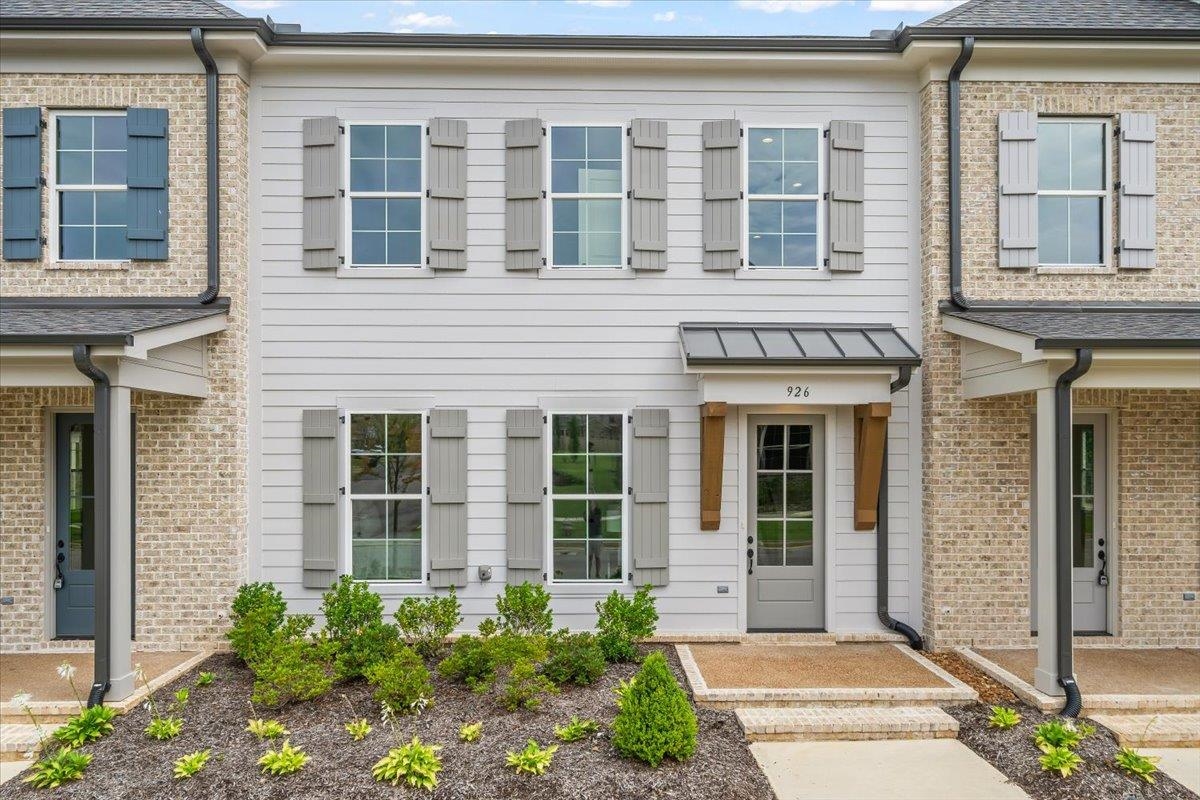 front view of a brick house with a large windows