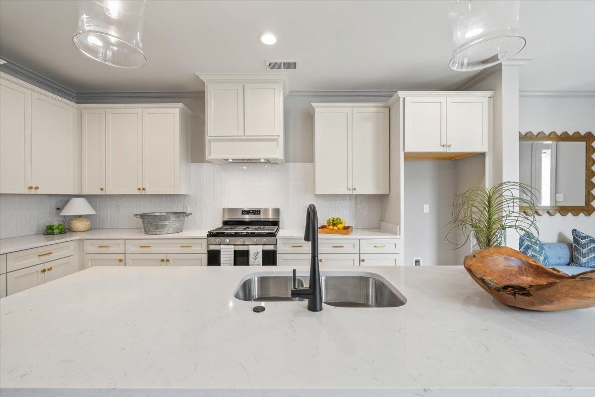 926 Aldwick Drive Collierville, TN 38017 - Photo 14 of 39 a kitchen with a sink a stove and cabinets