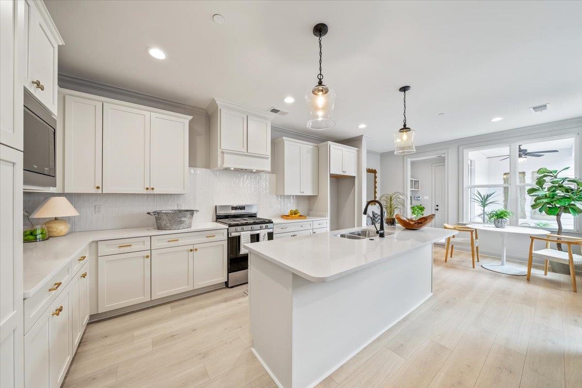 926 Aldwick Drive Collierville, TN 38017 - Photo 15 of 39 a large white kitchen with lots of counter space sink and appliances