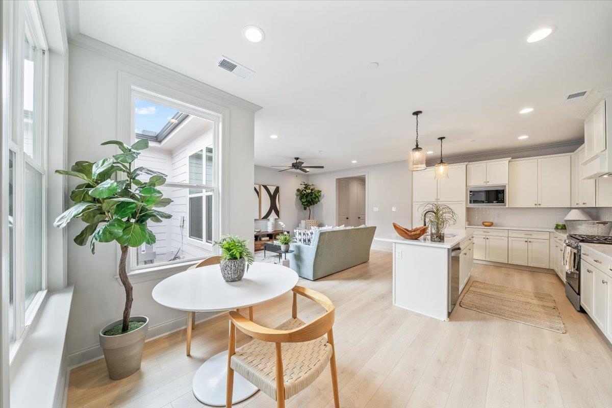926 Aldwick Drive Collierville, TN 38017 - Photo 19 of 39 a view of a dining room with furniture and a potted plant