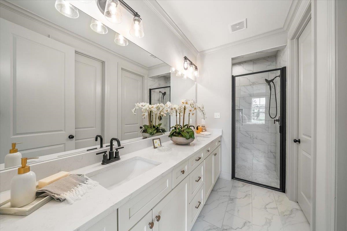 926 Aldwick Drive Collierville, TN 38017 - Photo 6 of 39 a bathroom with a double vanity sink mirror and bathtub
