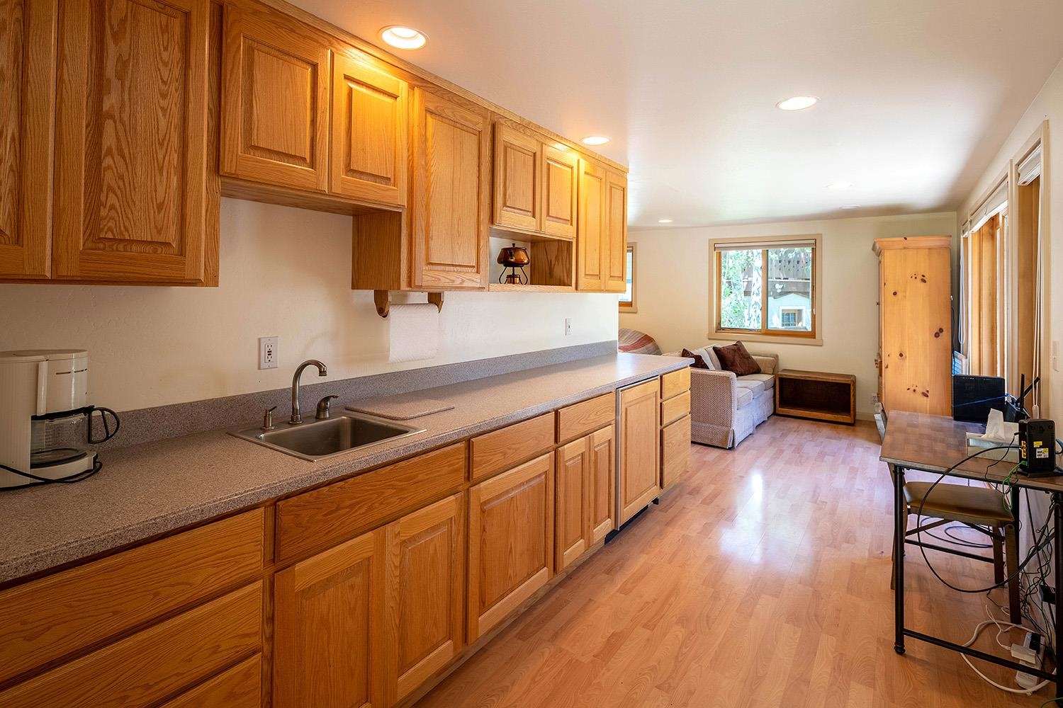 1281 Sandy Way Olympic Valley, CA 96146 - Photo 12 of 19 a kitchen with stainless steel appliances granite countertop wooden floors wooden cabinets and sink