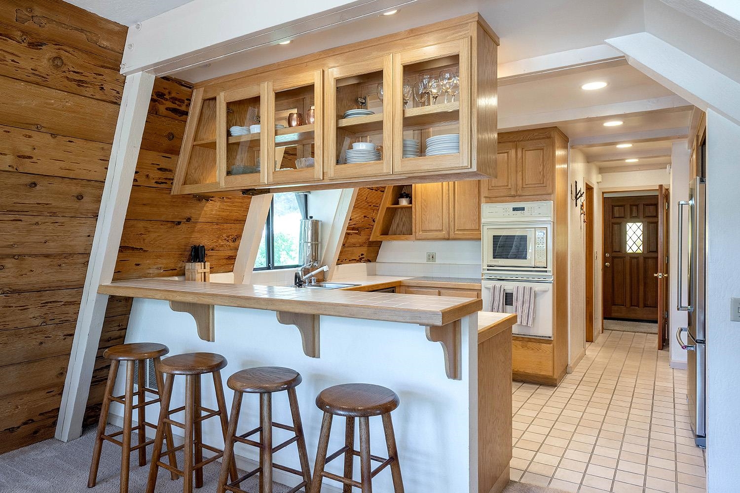 1281 Sandy Way Olympic Valley, CA 96146 - Photo 4 of 19 a kitchen with a dining table chairs sink and cabinets