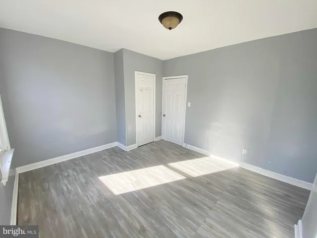 an empty room with wooden floor