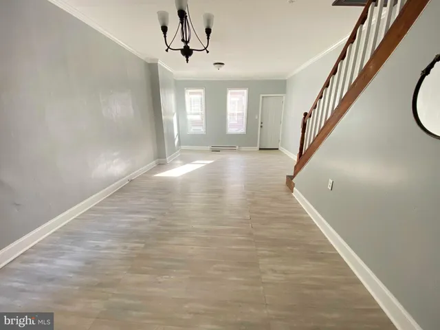 a view of an entryway with wooden floor