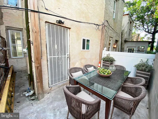 a view of a patio with furniture and a potted plant