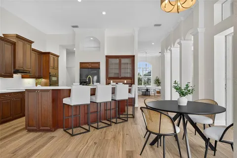 a living room with furniture a wooden floor and a sink