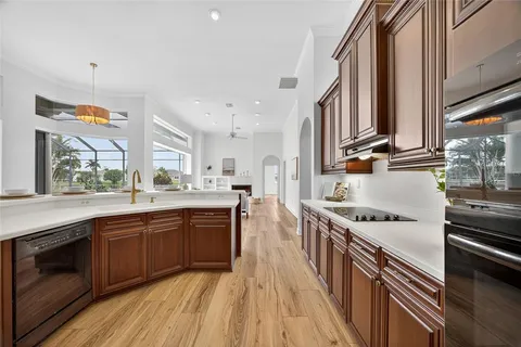 a kitchen with stainless steel appliances sink stove microwave and cabinets