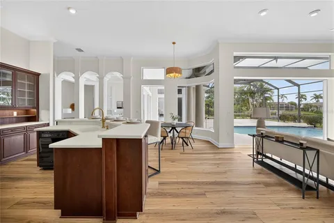 a large kitchen with stainless steel appliances granite countertop a lot of counter space and wooden floors