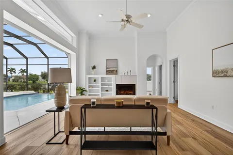 a living room with furniture a fireplace and a table