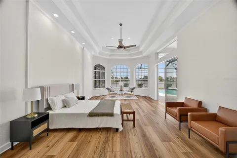 a living room with furniture fireplace and a large window