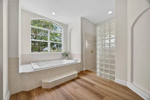 a spacious bathroom with a large tub and shower