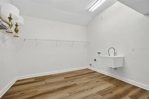 a view of a room with wooden floor and sink