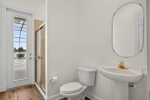 a bathroom with a sink a toilet and a mirror