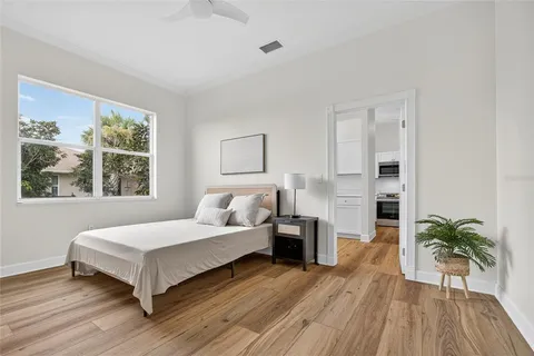 a bedroom with a bed and a large window