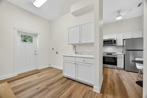 a kitchen with a sink stove and refrigerator