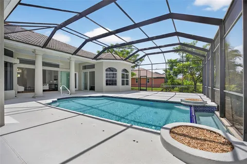 a view of a house with backyard porch and sitting area