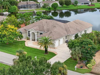 a aerial view of a house with a yard and potted plants