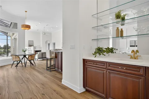 a hallway with cabinets and wooden floor