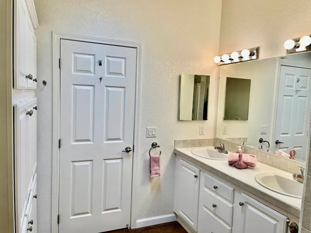 a bathroom with a double vanity sink mirror and