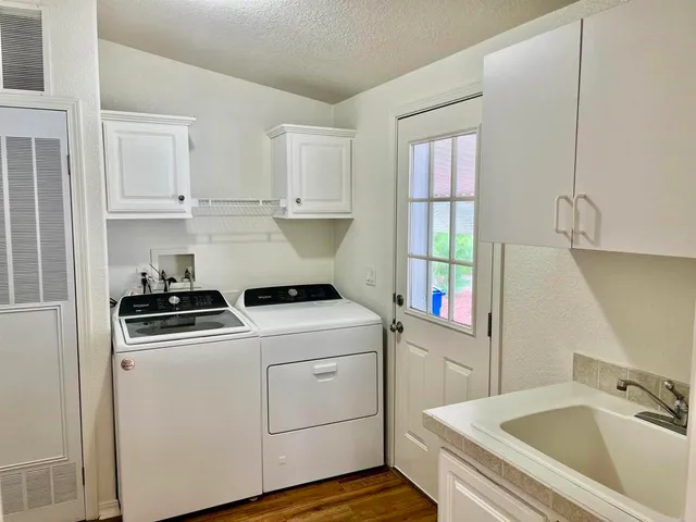 a utility room with sink dryer and washer