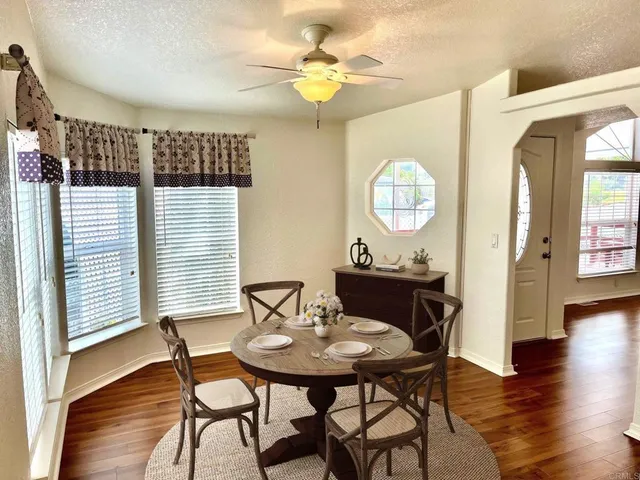 a view of a dining room with furniture and wooden floor