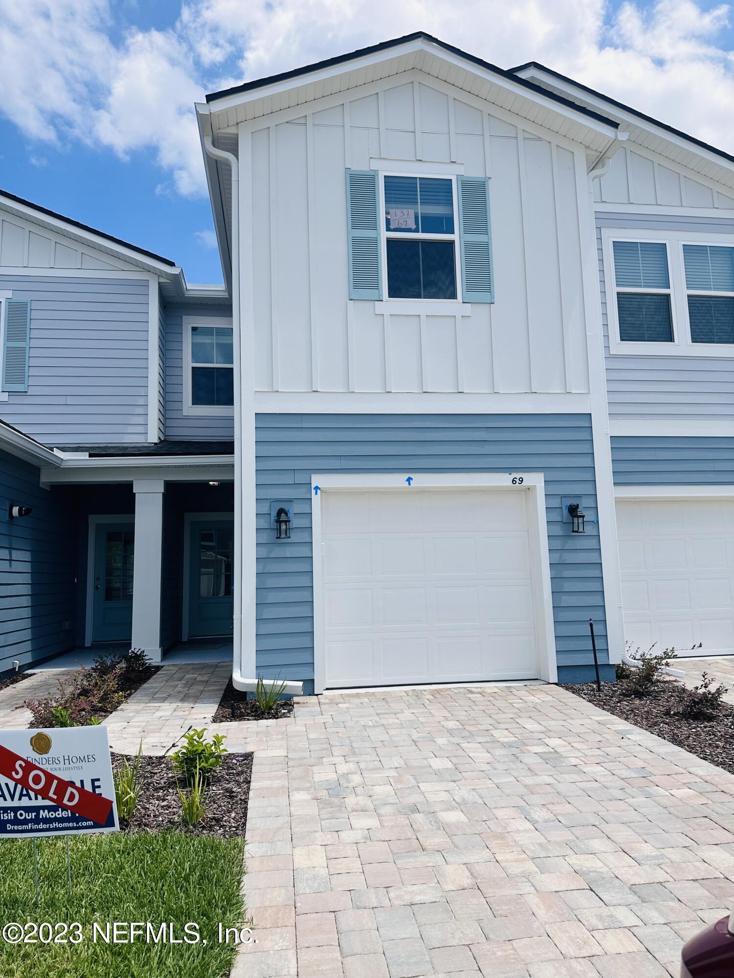 69 Thurnham Lane St. Augustine, FL 32092 - Photo 2 of 10 a front view of a house with a yard and garage