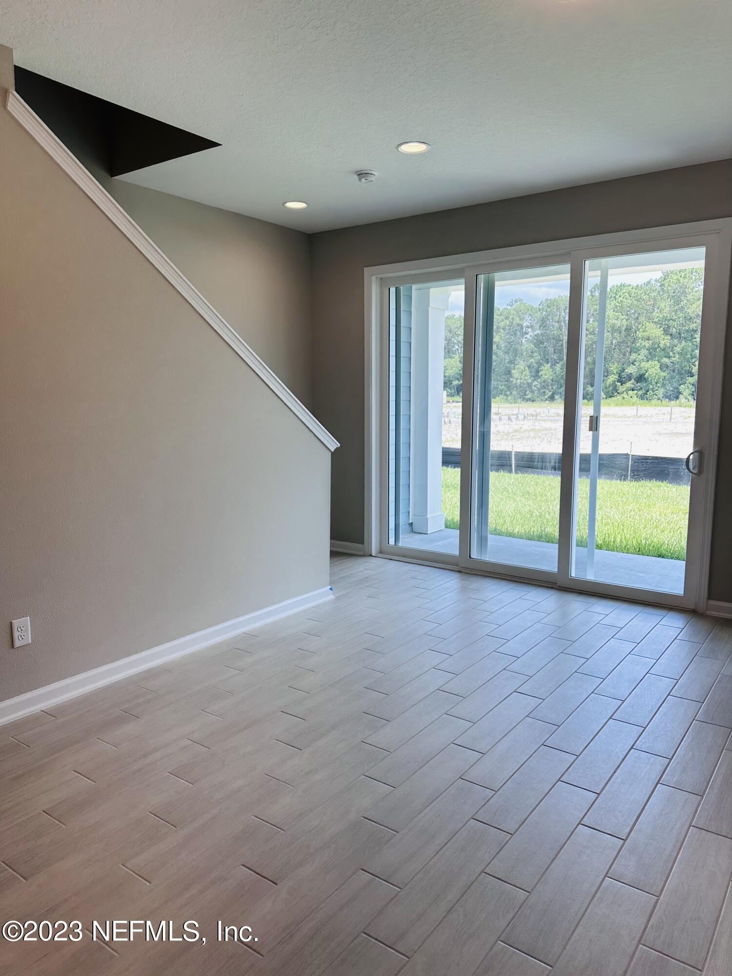 69 Thurnham Lane St. Augustine, FL 32092 - Photo 7 of 10 an empty room with windows