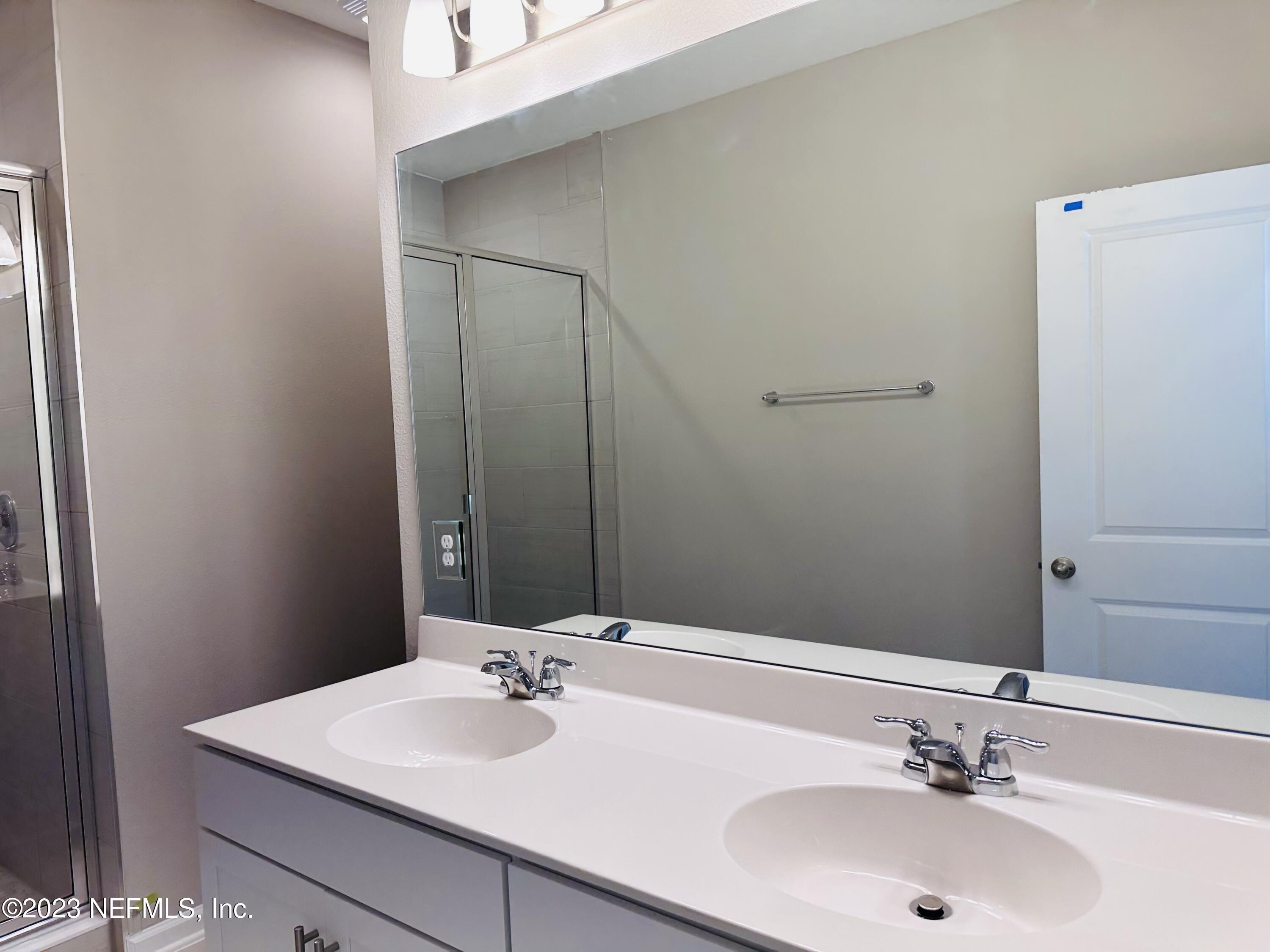 69 Thurnham Lane St. Augustine, FL 32092 - Photo 9 of 10 a bathroom with a sink and a mirror