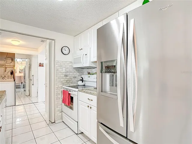 a kitchen with stainless steel appliances a refrigerator sink and cabinets