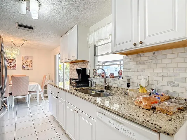 a living room with a couch and a floor to ceiling window