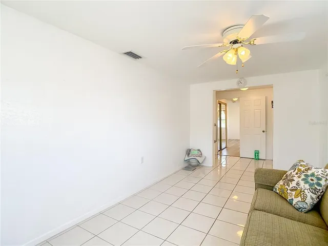 a bedroom with a bed and a lamp