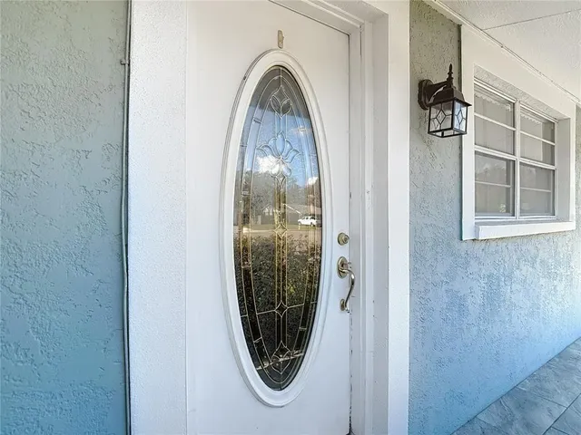 a view of a patio with table and chairs potted plants