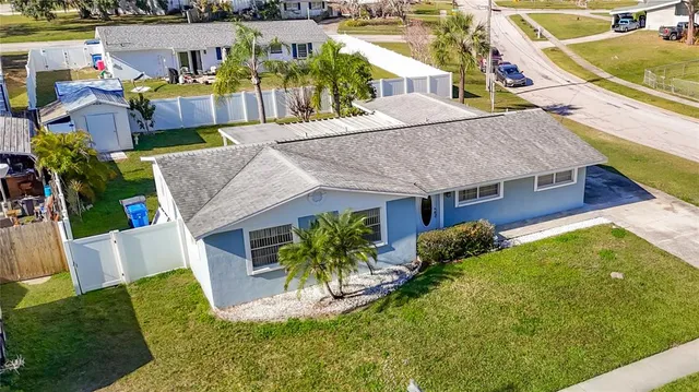 a house with lots of trees in the background