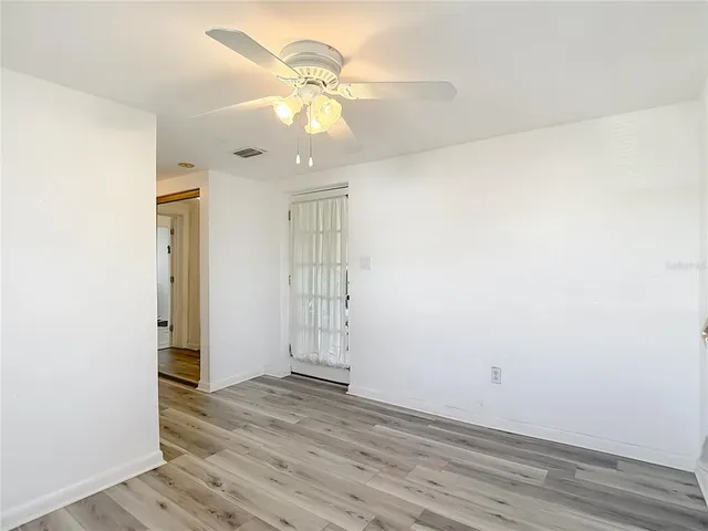 a view of a dining room with furniture large windows and wooden floor