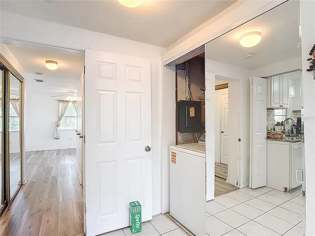 a view of a house with table and chairs under an umbrella
