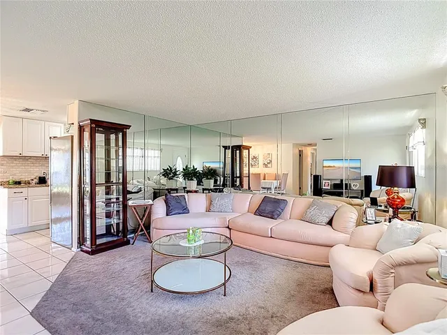 an aerial view of residential houses with outdoor space and swimming pool